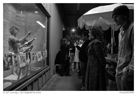 People watch performance artists in window, Bergamot Station. Santa Monica, Los Angeles, California, USA