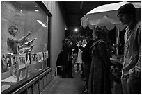 People watch performance artists in window, Bergamot Station. Santa Monica, Los Angeles, California, USA (black and white)