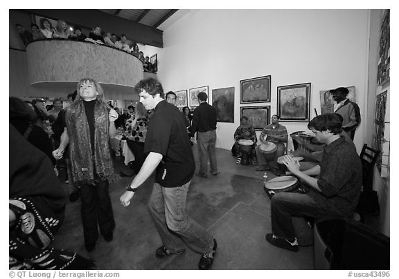 Guest dance to drums on art gallery opening night, Bergamot Station. Santa Monica, Los Angeles, California, USA (black and white)