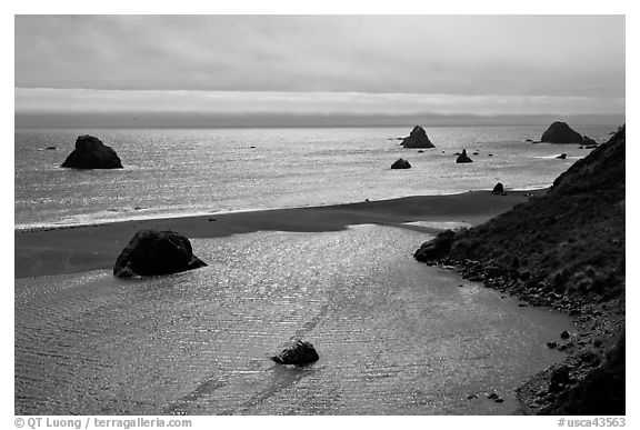 Shimmering ocean and river separated by sliver of sand, Jenner. Sonoma Coast, California, USA