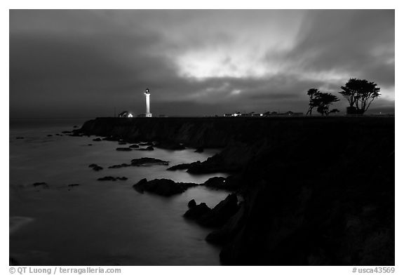 Coastal bluff with lighthouse at dusk, Point Arena. California, USA (black and white)