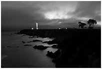 Coastal bluff with lighthouse at dusk, Point Arena. California, USA (black and white)