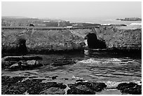 Sea cliffs with sea arches. California, USA (black and white)