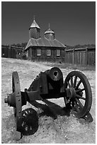 Cannon and Russian chapel inside Fort Ross. Sonoma Coast, California, USA ( black and white)