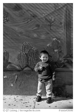 Boy and mural, Mission District. San Francisco, California, USA (black and white)