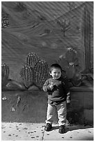 Boy and mural, Mission District. San Francisco, California, USA (black and white)