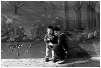 Boys and mural, Mission District. San Francisco, California, USA ( black and white)