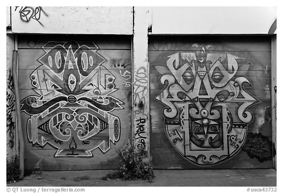Two painted garage doors, Mission District. San Francisco, California, USA