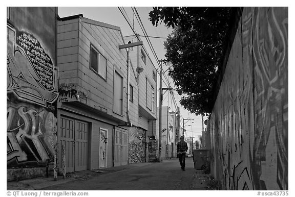 Man walking in alley, Mission District. San Francisco, California, USA