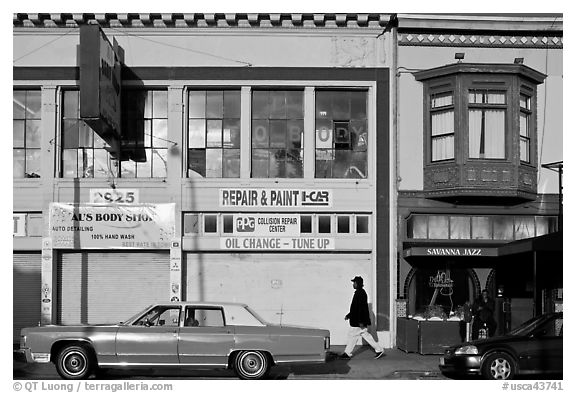 Old car and sidewalk, Mission Street, Mission District. San Francisco, California, USA (black and white)