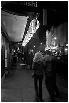 Couple on Castro street at night. San Francisco, California, USA (black and white)