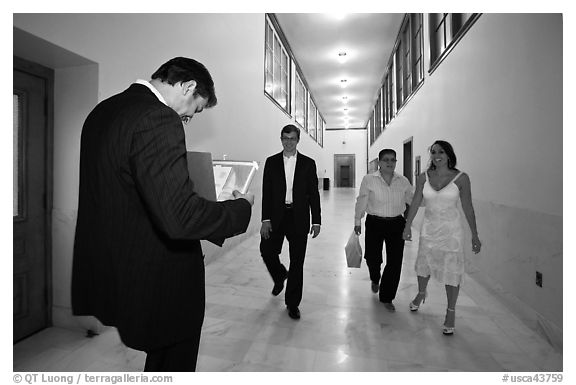 Soon to be maried couple and witness in City Hall corridor. San Francisco, California, USA