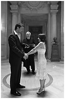 Bride, groom, and wedding officant, City Hall. San Francisco, California, USA ( black and white)