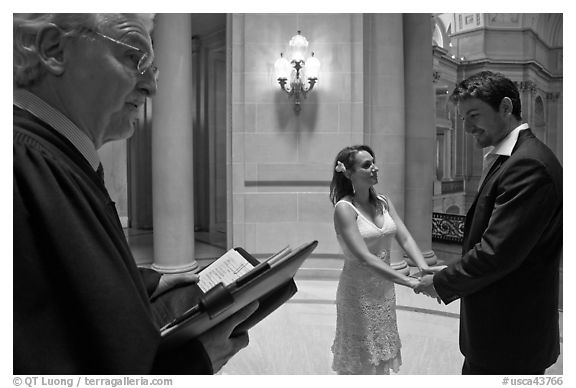 Officiant and couple getting married, City Hall. San Francisco, California, USA (black and white)
