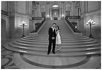 Just married couple at the base of the grand staircase, City Hall. San Francisco, California, USA (black and white)