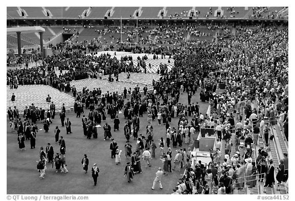 Audience and graduates mingling in stadium after commencement. Stanford University, California, USA (black and white)