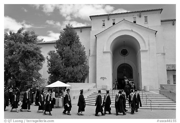 Graduates walking single file into Memorial auditorium. Stanford University, California, USA (black and white)
