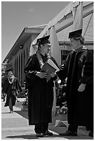 Graduate wearing lei presented with diploma. Stanford University, California, USA (black and white)