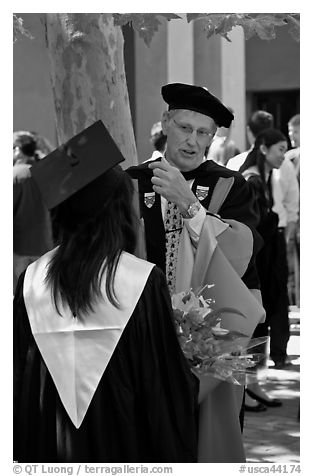 Faculty in academic dress talks with student. Stanford University, California, USA