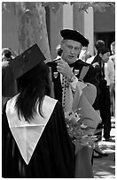 Faculty in academic dress talks with student. Stanford University, California, USA (black and white)