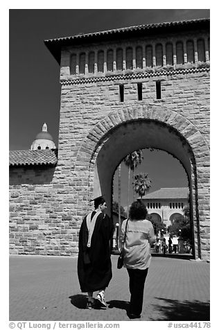 Graduate and family member walking through Main Quad. Stanford University, California, USA (black and white)