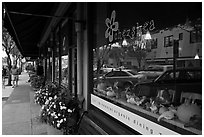 Main street reflected in storefront. Half Moon Bay, California, USA ( black and white)