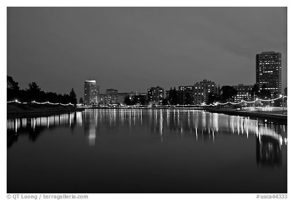 Oakland skyline reflected in Lake Meritt, twilight. Oakland, California, USA