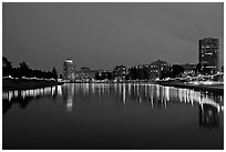 Oakland skyline reflected in Lake Meritt, twilight. Oakland, California, USA (black and white)