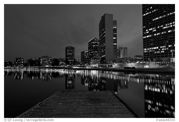 High-rise buildings, deck, and Lake Meritt, dusk. Oakland, California, USA