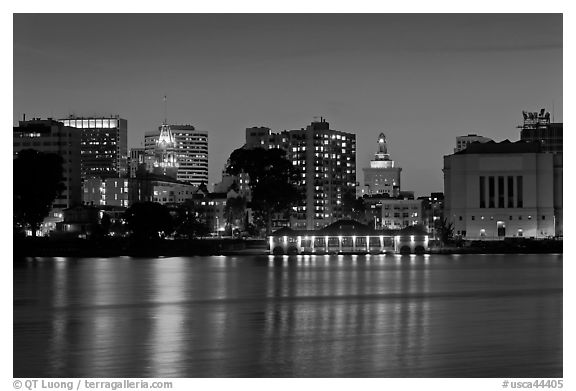 Oakland skyline reflected in Lake Merritt at night. Oakland, California, USA (black and white)