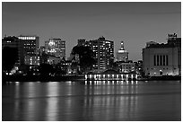 Oakland skyline reflected in Lake Merritt at night. Oakland, California, USA (black and white)