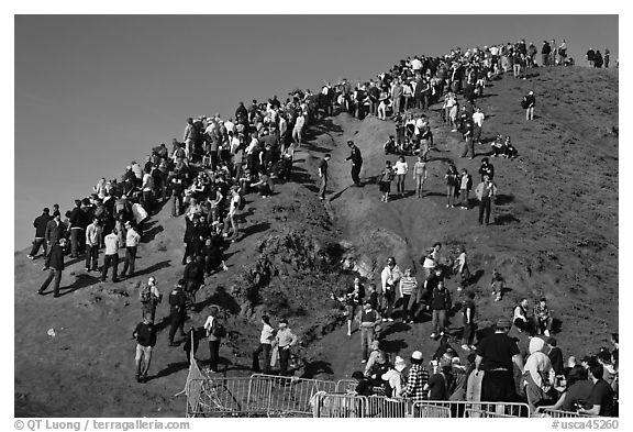 Crowds scrambling on hill during mavericks competition. Half Moon Bay, California, USA (black and white)