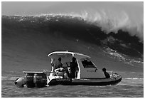 Small boat dwarfed by huge wave. Half Moon Bay, California, USA ( black and white)