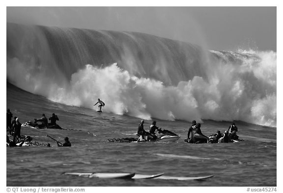 Waverunners and surfer in big wave. Half Moon Bay, California, USA (black and white)