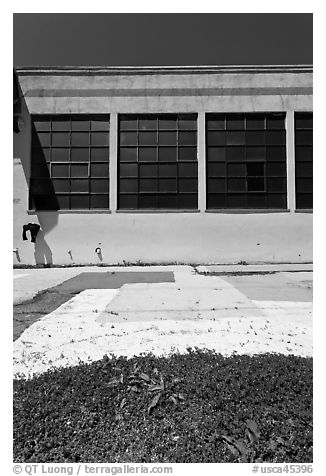 Sidewalk and industrial building facade. Berkeley, California, USA (black and white)