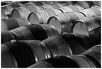 Rows of wine barrels in cellar, close-up. Napa Valley, California, USA (black and white)