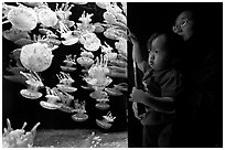 Mother and infant look at Jelly exhibit, Monterey Bay Aquarium. Monterey, California, USA ( black and white)
