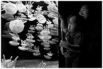 Mother and infant look at Jelly exhibit, Monterey Bay Aquarium. Monterey, California, USA (black and white)