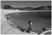 Women stroll on Carmel River Beach. Carmel-by-the-Sea, California, USA ( black and white)