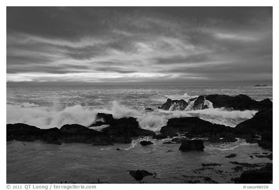 Wave crashing on rock at sunset. Point Lobos State Preserve, California, USA (black and white)