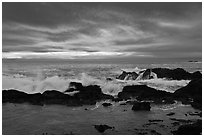 Wave crashing on rock at sunset. Point Lobos State Preserve, California, USA ( black and white)