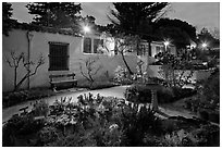 Garden and historic adobe house at night. Monterey, California, USA (black and white)
