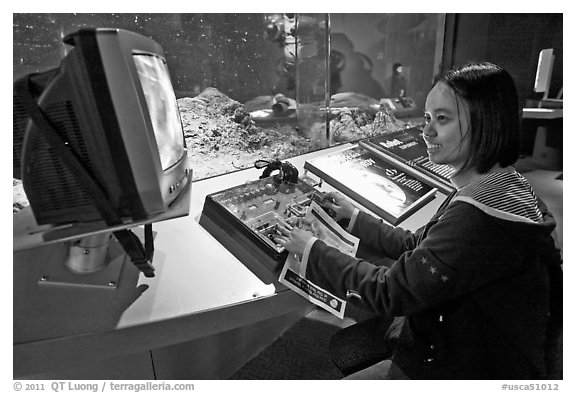 Woman controls robot, Tech Museum. San Jose, California, USA (black and white)