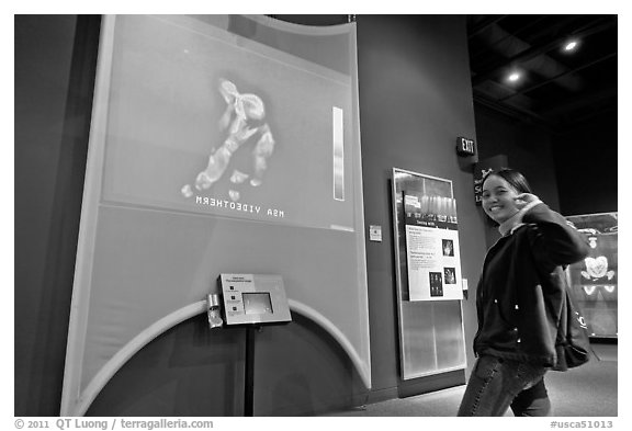 Woman imaged by thermal camera, Tech Museum. San Jose, California, USA (black and white)