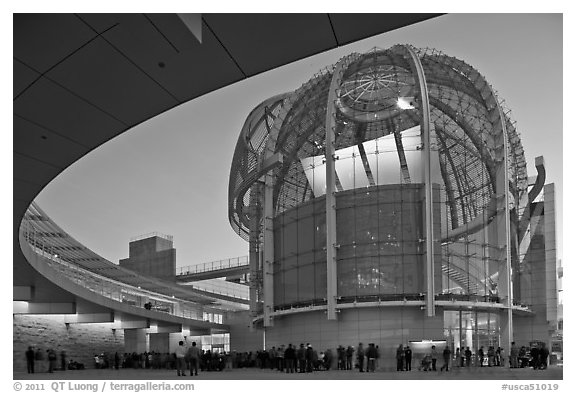 Crowd gathered around rotunda at dusk, San Jose City Hall. San Jose, California, USA (black and white)