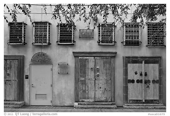 Wall with weathered doors and windows. Santana Row, San Jose, California, USA (black and white)