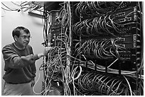 Technician rearranging data cables. Menlo Park,  California, USA (black and white)