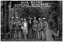 Rangers posing with Theodore Roosevelt under entrance gate. Muir Woods National Monument, California, USA (black and white)