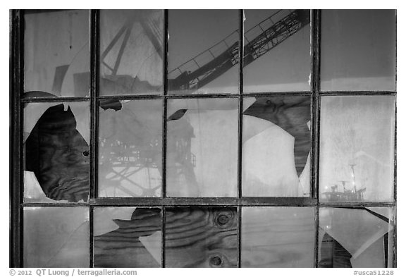Crane reflected in broken windows, Rosie the Riveter Home Front National Historical Park. Richmond, California, USA (black and white)