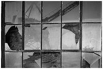 Crane reflected in broken windows, Rosie the Riveter Home Front National Historical Park. Richmond, California, USA ( black and white)